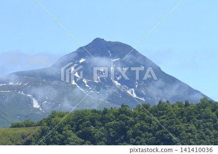 A beautiful view of Mount Rausu with lingering snow in the season of fresh greenery. A beautiful view of Mount Rausu with lingering snow in the season of fresh greenery. 141410036