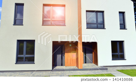 Newly constructed semi detached house for families. Modern design, technology, and real estate market concept. Newly constructed semi detached house for families. Modern design, technology, and real estate market concept. 141410086