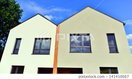 Newly constructed semi detached house for families. Modern design, technology, and real estate market concept. Newly constructed semi detached house for families. Modern design, technology, and real estate market concept. 141410087
