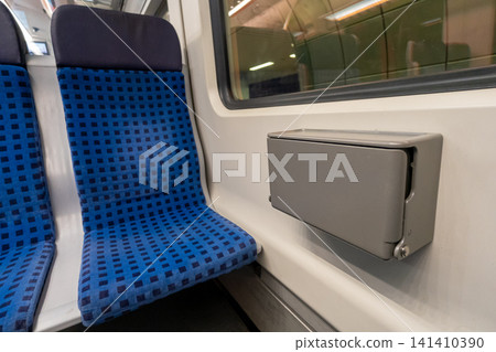 Small trash bin mounted between seats inside German S-Bahn train carriage Small trash bin mounted between seats inside German S-Bahn train carriage 141410390
