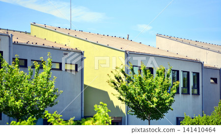 Eco building in modern city concept. Fresh green trees and office building, business concept. Eco building in modern city concept. Fresh green trees and office building, business concept. 141410464