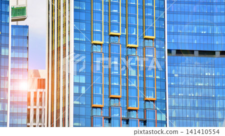 View of modern residential building with glass balconies and bright facade. Contemporary apartment building in european city. Concept of urban living and modern architecture. View of modern residential building with glass balconies and bright facade. Contemporary apartment building in european city. Concept of urban living and modern architecture. 141410554