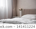 Bright cozy bedroom interior with white bed and copy space 141411224