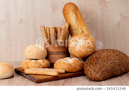 Fresh crispbread. Bread background. Different breed on wooden background. Fresh crispbread. Bread background. Different breed on wooden background. 141411246