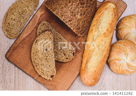 French baguettes. Fresh crispbread. Bread background. Different breed  on wooden background. 141411292