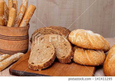 French baguettes. Fresh crispbread. Bread background. Different breed  on wooden background. 141411295