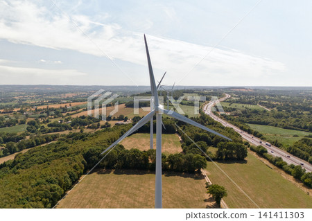 Overhead Aerial View of Wind Turbine Amid Farmland and Road 141411303