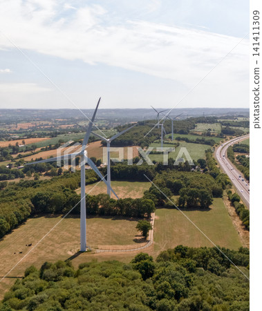 Wind Turbine Rising Above Green Fields Generates Renewable Energy Wind Turbine Rising Above Green Fields Generates Renewable Energy 141411309