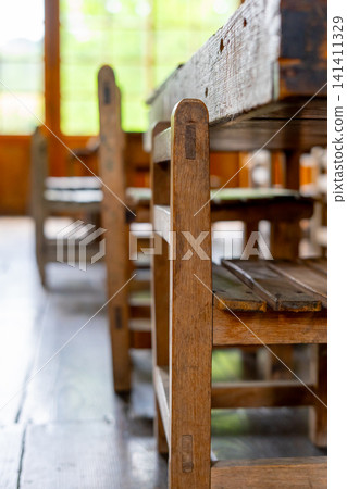 Chairs in the classrooms of old Japanese elementary schools, made of wood; Showa retro style. 141411329