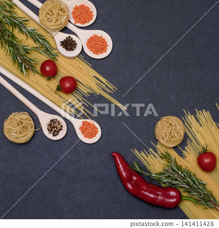 Italian food ingredients.Still life of cooking pasta on a black background top view. Wooden spoons with spices. Frame of products and vegetables. Italian food ingredients.Still life of cooking pasta on a black background top view. Wooden spoons with spices. Frame of products and vegetables. 141411428