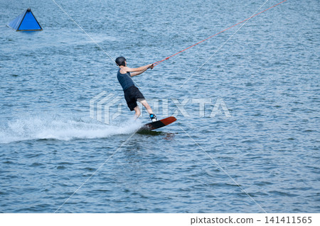 Cable Wakeboarder Riding on Lake in Summer 141411565