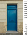 Blue painted door in classical building facade, Paris, France, representing entrance and home concept 141411814