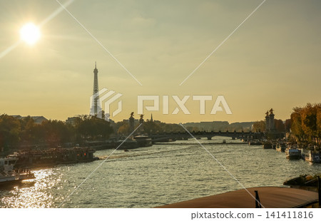 Eiffel Tower and Seine river at sunset with Pont Alexandre III, iconic Paris travel destination Eiffel Tower and Seine river at sunset with Pont Alexandre III, iconic Paris travel destination 141411816
