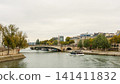 Paris cityscape showing Pont de la Tournelle on Seine River with an historic obelisk and cruise boat passing by 141411832