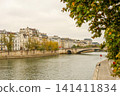 Seine River flowing through Paris with historic buildings and Pont Neuf bridge under autumn leaves 141411834