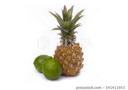 Pineapple and lime on a white background. Lime and pineapple close-up on an isolated white background. Pineapple and lime on a white background. Lime and pineapple close-up on an isolated white background. 141411953