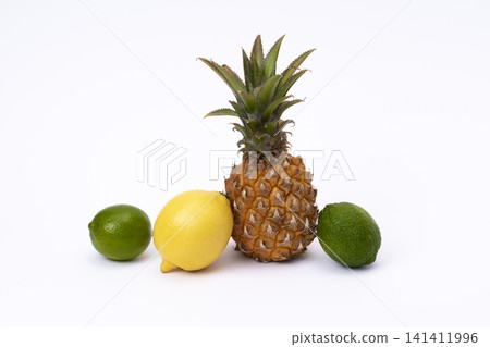 Pineapple with lemon and lime on a white background. Green lime, pineapple close-up and yellow lemon on an isolated white background. 141411996