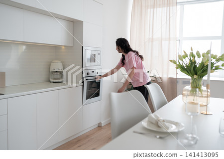 Portrait of a woman in the kitchen of her home for health diet or nutrition. Smile, food and cooking Portrait of a woman in the kitchen of her home for health diet or nutrition. Smile, food and cooking 141413095