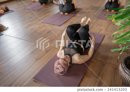 Woman, instructor and yoga class for fitness, stretching or back at wellness retreat. Yogi, group exercise and people with trainer at resort for balance, healing and health with side bend outdoor Woman, instructor and yoga class for fitness, stretching or back at wellness retreat. Yogi, group exercise and people with trainer at resort for balance, healing and health with side bend outdoor 141413203