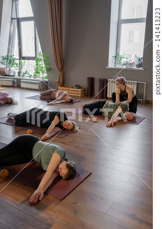 Women three generations doing different yoga exercises lying on back. Women's health of joints and spine Women three generations doing different yoga exercises lying on back. Women's health of joints and spine 141413223