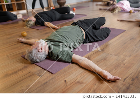 Women three generations doing different yoga exercises lying on back. Women's health of joints and spine Women three generations doing different yoga exercises lying on back. Women's health of joints and spine 141413335