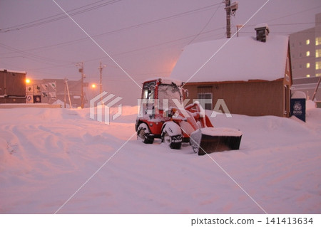 A wheel loader standing in the sunset. A wheel loader standing in the sunset. 141413634