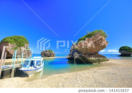 [Okinawa Prefecture] Mibaru Beach and rocky reef under a clear blue sky. 141413837