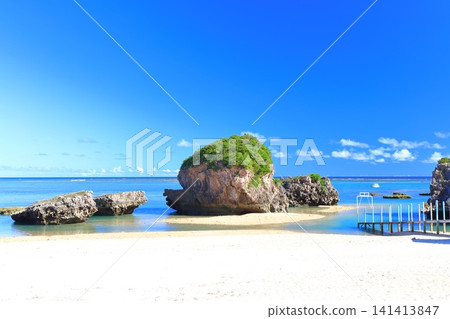 [Okinawa Prefecture] Mibaru Beach and rocky reef under a clear blue sky. 141413847
