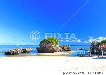 [Okinawa Prefecture] Mibaru Beach and rocky reef under a clear blue sky. 141413851