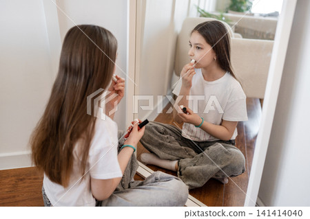 Teen brushing long hair on bed and talking with friend sitting on bedroom floor. Hair, brushing, teen, bed, friend, bedroom, talking. Teen brushing long hair on bed and talking with friend sitting on bedroom floor. Hair, brushing, teen, bed, friend, bedroom, talking. 141414040