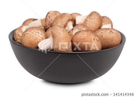 Brown champignon mushroom in a ceramic bowl isolated on white background Brown champignon mushroom in a ceramic bowl isolated on white background 141414348