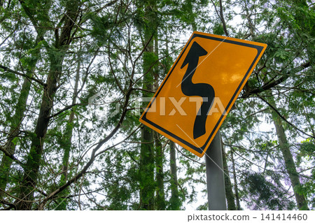 Warning sign installed in a man-made forest (with switchbacks) Warning sign installed in a man-made forest (with switchbacks) 141414460