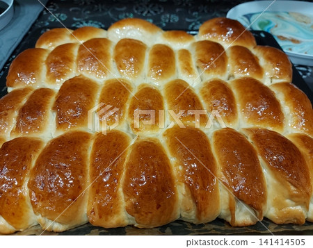 Sweet pies with filling lying on a baking sheet, top view. Sweet pies with filling lying on a baking sheet, top view. 141414505