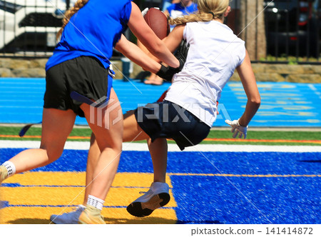 Girls Catching Football in the End Zone for a Touchdown During a Flag Football Game Girls Catching Football in the End Zone for a Touchdown During a Flag Football Game 141414872
