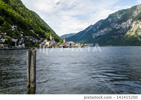 Hallstatt village and scenic lakeside in the Austrian Alps, illustrating European small town charm with classic summer atmosphere. Hallstatt village and scenic lakeside in the Austrian Alps, illustrating European small town charm with classic summer atmosphere. 141415200