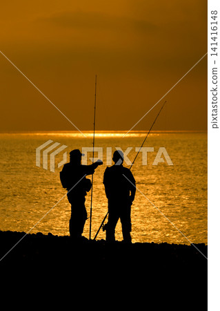 A fisherman in silhouette A fisherman in silhouette 141416148
