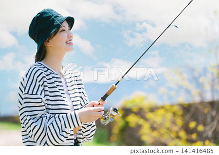A young woman enjoying fishing as a hobby 141416485