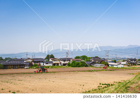 The tranquil rural landscape of Asahi Village and the distant mountains 141416630