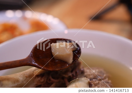 Spoon Holding Tofu in Soup Bowl Close-up Spoon Holding Tofu in Soup Bowl Close-up 141416713