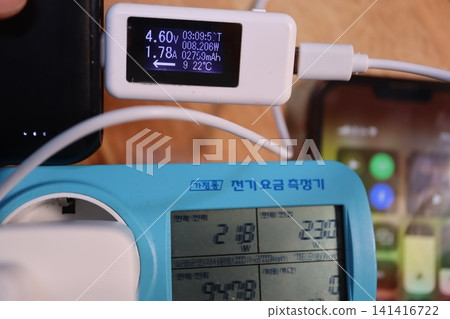 USB Power Monitor Displaying Voltage and Current Readings USB Power Monitor Displaying Voltage and Current Readings 141416722