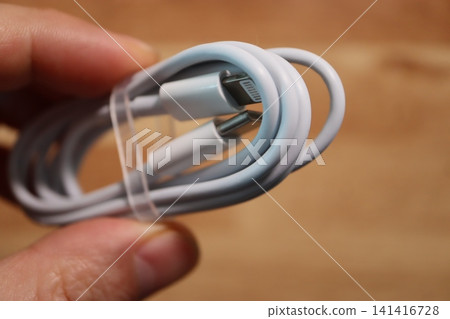 Hand Holding Coiled USB Cable Close-up Hand Holding Coiled USB Cable Close-up 141416728