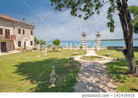 Seaside garden of Dajla monastery with pillars and sea view. Seaside garden of Dajla monastery with pillars and sea view. 141416918