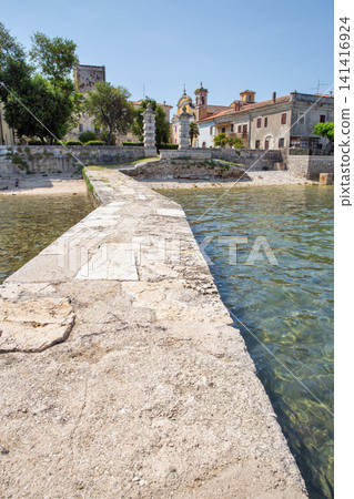 Stone pier leading to Dajla monastery in Istria, Croatia. 141416924