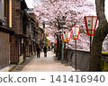 A spring scene of cherry blossoms in full bloom and paper lanterns along the Asano River in the Kazue-machi Chaya District of Kanazawa City, Ishikawa Prefecture. 141416940