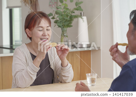 A close senior couple enjoying tea time together A close senior couple enjoying tea time together 141417039