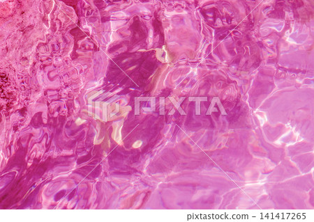 Abstract background texture of wavy transparent pool water illuminated with bright pink light suitable for vivid summer design banner or beauty cosmetic packaging Abstract background texture of wavy transparent pool water illuminated with bright pink light suitable for vivid summer design banner or beauty cosmetic packaging 141417265