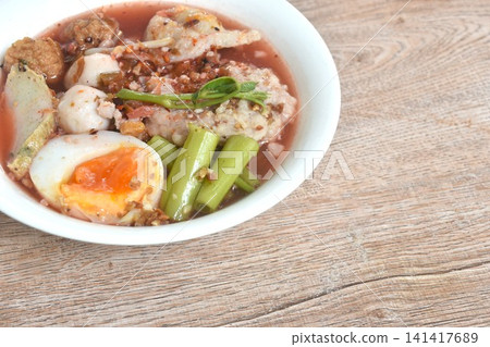 boiled fish and shrimp meatball with morning glory topping mashed pork couple creamy egg in spicy red sauce tom yum soup on bowl boiled fish and shrimp meatball with morning glory topping mashed pork couple creamy egg in spicy red sauce tom yum soup on bowl 141417689