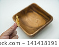 The hand holding the last potato chip The hand holding the last potato chip 141418191