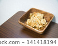 Potato chips served in a wooden bowl Potato chips served in a wooden bowl 141418194