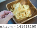Potato chips served in a wooden bowl Potato chips served in a wooden bowl 141418195